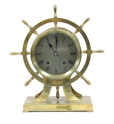 Lot 219 - A brass ship's wheel mantel clock, the...