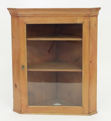 Lot 253 - A pine corner cupboard with glazed door,...