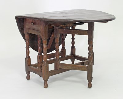 Lot 254 - An 18th Century oak gateleg table, the oval...