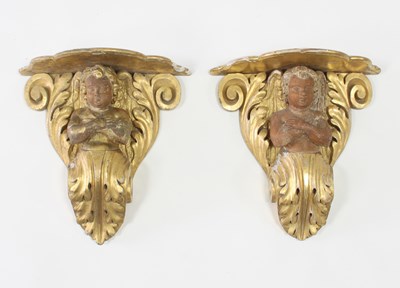 Lot 299 - A pair of carved and gilded wall brackets with...