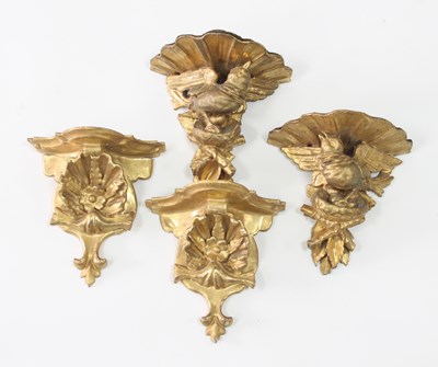 Lot 300 - Two pairs of carved and gilded wall brackets...