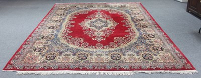 Lot 311 - A Kerman carpet with all over floral field and...