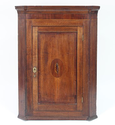 Lot 320 - An early 19th Century oak corner cupboard with...