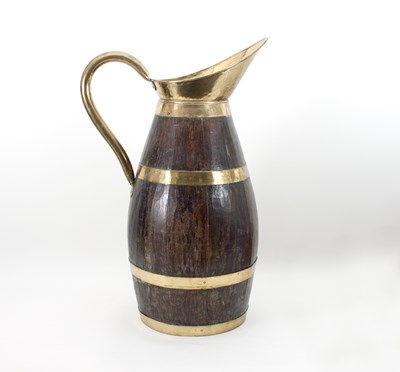 Lot 406 - A brass bound teak ewer, 71cm high