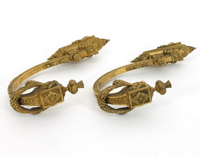 Lot 408 - A pair of gilt metal tie backs, each decorated...