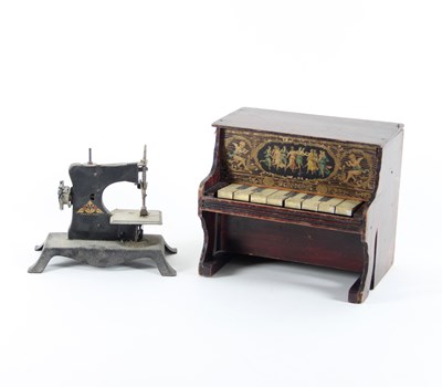 Lot 663 - A child's toy piano and a child's sewing...