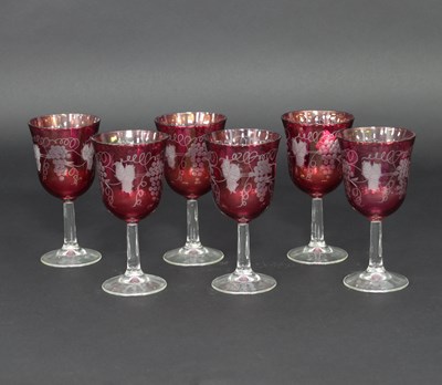 Lot 679 - Six ruby tinted glasses, etched grapes and...