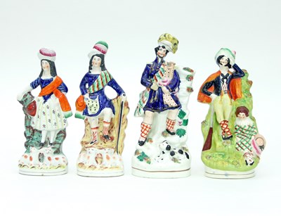 Lot 711 - A group of four Staffordshire figures,...