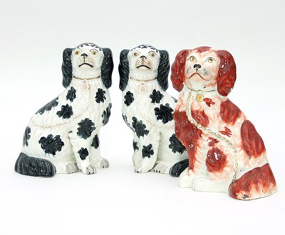 Lot 716 - A pair of black and white Staffordshire dogs,...