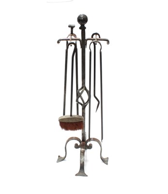 Lot 66 - An Arts and Crafts style matched fire iron set,...