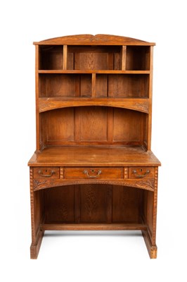 Lot 394 - An Arts & Crafts style oak bookcase and desk