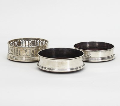 Lot 446 - Three modern silver wine coasters, each...