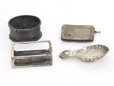 Lot 476 - A silver caddy spoon, a silver napkin ring, a...