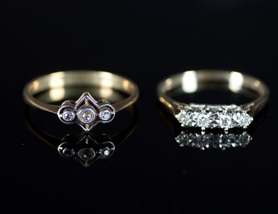 Lot 513 - A diamond four-stone ring in an illusion...