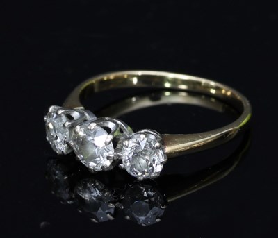 Lot 525 - A three-stone diamond ring, the stones claw...