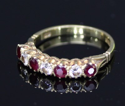 Lot 529 - A seven-stone ruby and diamond ring, the...