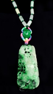 Lot 544 - A carved jade pendant depicting a bird, a fish...