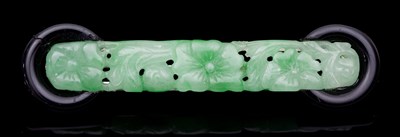 Lot 545 - A jade and onyx brooch, the carved jade plaque...