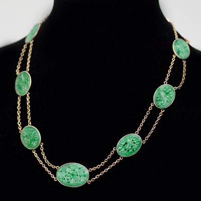 Lot 546 - A Chinese jade plaque necklace, the nine oval...