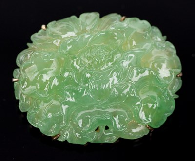 Lot 549 - A Chinese carved jade brooch of oval...