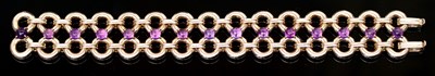 Lot 551 - An amethyst and gold bracelet, the double row...