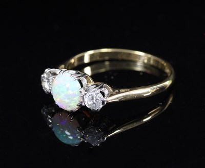 Lot 556 - An opal and diamond three-stone ring, the...