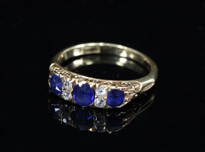 Lot 563 - A sapphire and diamond ring, the three...