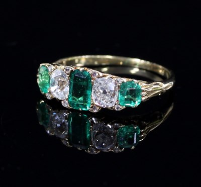 Lot 567 - An emerald and diamond five-stone ring, the...