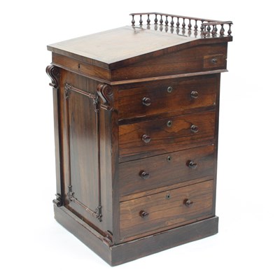 Lot 653 - A Regency rosewood Davenport, the sliding top...