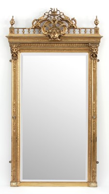 Lot 669 - A giltwood wall mirror of Empire design, the...