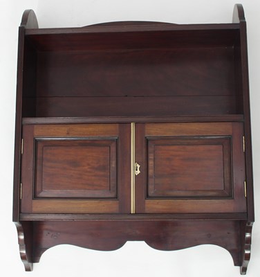 Lot 678 - A mahogany wall shelf, the open shelf above...