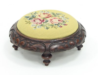 Lot 681 - An oak circular foot stool with carved...