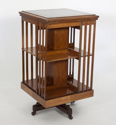 Lot 693 - An Edwardian oak two-tier revolving bookcase...