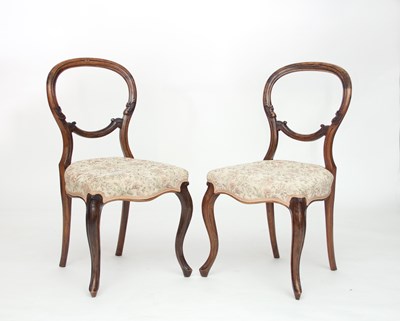 Lot 721 - A pair of Victorian walnut balloon back dining...