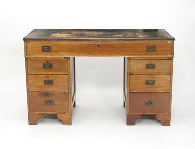 Lot 758 - An oak kneehole desk fitted a surround of...