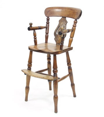 Lot 811 - A child's high chair in elm with vase shaped...