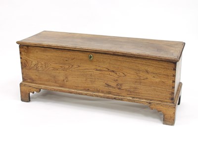 Lot 813 - An elm chest with plain hinged cover on...