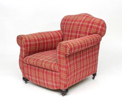 Lot 831 - An upholstered armchair on bun feet with castors