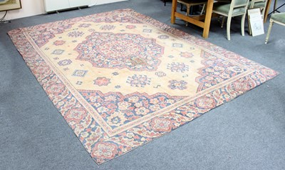 Lot 852 - A woven rug the central medallion on a camel...