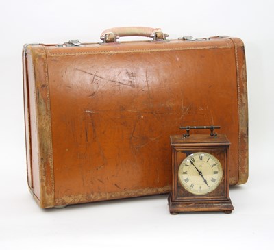 Lot 875 - A tan leather suitcase, mounted with white...