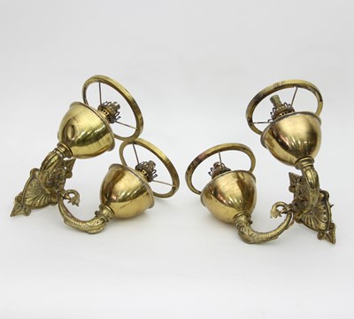 Lot 878 - Two brass wall oil lamps with dolphin supports