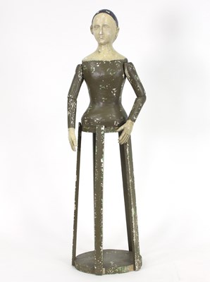 Lot 922 - A painted mannequin with articulated arms on a...