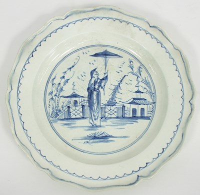 Lot 976 - A creamware dish painted an Oriental figure in...