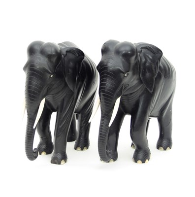 Lot 1024 - A pair of ebony elephants, 26cm high