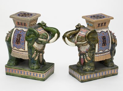 Lot 1073 - A pair of Chinese pottery elephant seats, each...