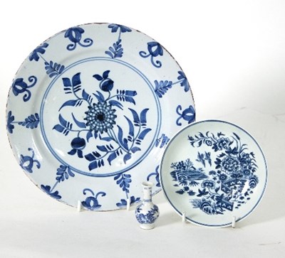 Lot 23 - A Delft plate decorated with floral sprays,...