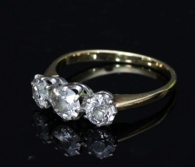 Lot 111 - A three-stone diamond ring, the stones claw...