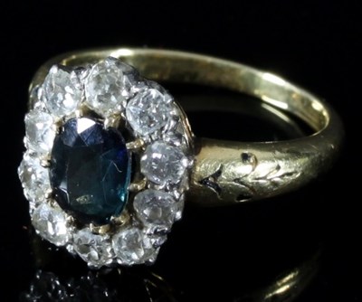 Lot 122 - A diamond and Australian sapphire cluster ring,...