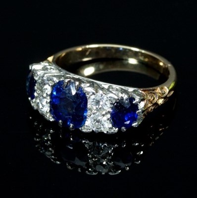 Lot 146 - A sapphire and diamond ring, set with three...