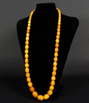 Lot 159 - An amber bead necklace, the fifty-eight...